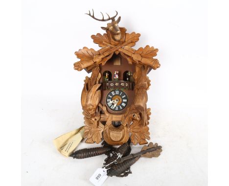 A German Black Forest cuckoo clock, case height 40cm, with weights and pendulum 