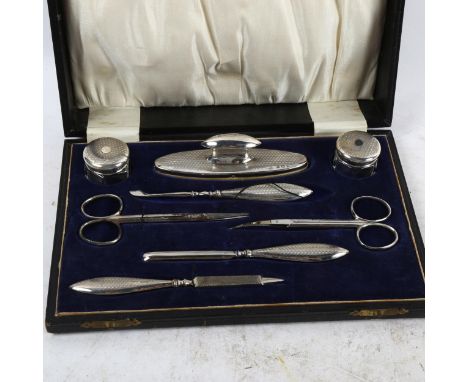 An early 20th century 8-piece engine turned silver manicure set, in fitted case 