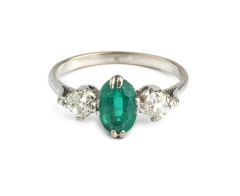 A soudé emerald and diamond three stone ring, the oval mixed-cut composite green stone claw set between two old-cut diamonds,