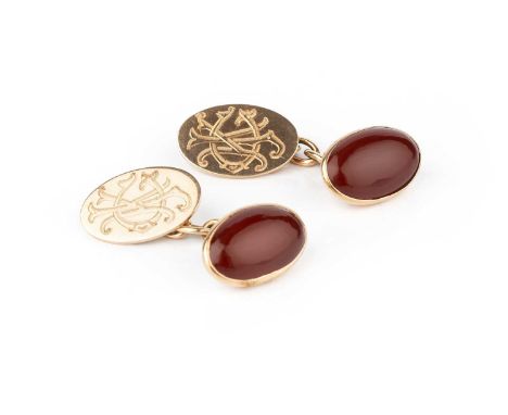 A pair of carnelian cufflinks, the oval carnelian cabochons in closed-back collet settings, on chain-link fittings with oval 