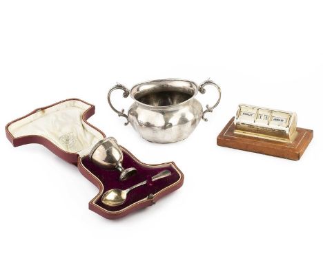 An Edwardian silver twin handled sucrier, of shaped oval form, London 1908, 16.5cm wide, a silver egg cup and spoon, by Golds