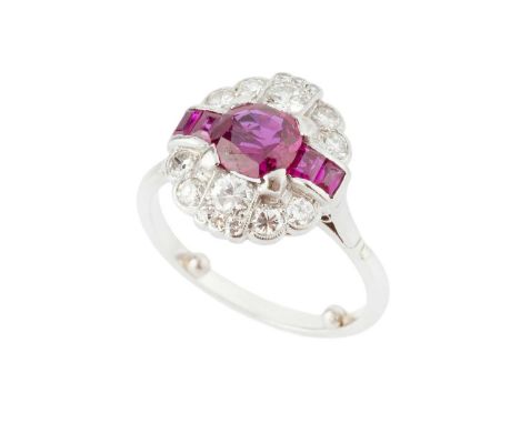 A ruby and diamond panel ring, the shaped oval millegrained panel centred with a cushion-shaped mixed-cut ruby between pairs 
