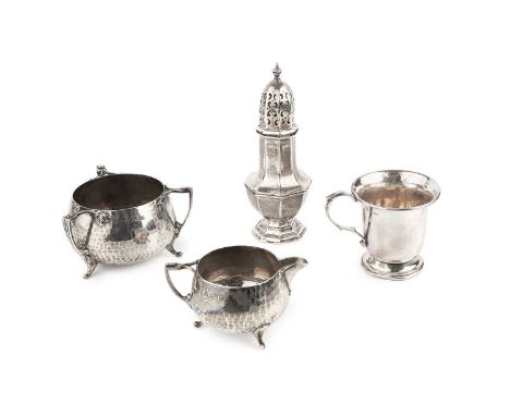An Edwardian silver Arts &amp; Crafts style sucrier, with three angular flowerhead handles, spot hammered body and shaped fee
