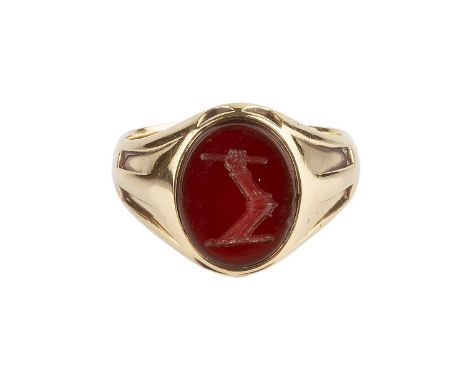 A late Victorian hardstone signet ring, the oval carnelian intaglio with incised crest, to a tapered 18ct gold mount with flu