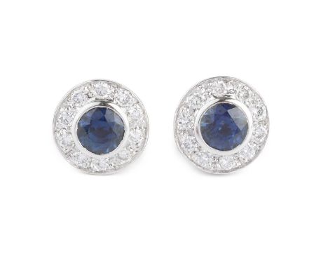 A pair of sapphire and diamond cluster ear studs, ear circular mixed-cut sapphire collet set within a border of round brillia