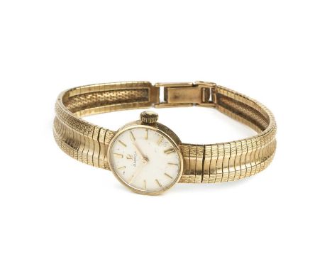 A lady's 9ct gold bracelet watch by Omega, the circular silvered dial with gilt baton markers, to a calibre 620 jewelled manu
