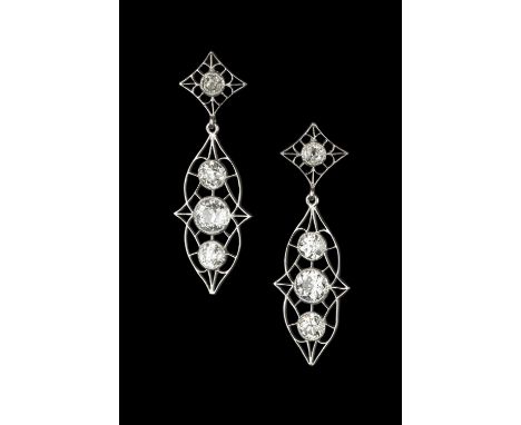 A pair of diamond ear pendants, each openwork lozenge-shaped drop centred with a trio of old-cut diamonds in millegrain colle