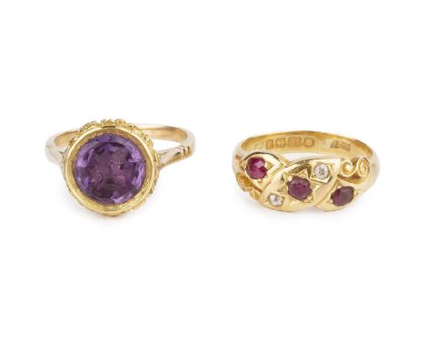 A late Victorian ruby and diamond dress ring, of scrolled design, highlighted with a trio of oval and circular mixed-cut rubi