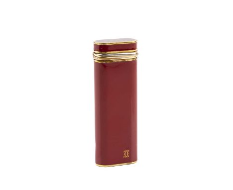 A gilt metal and burgundy enamel lighter, by Cartier, of rounded rectangular form, no. 45761M, 7cm high.