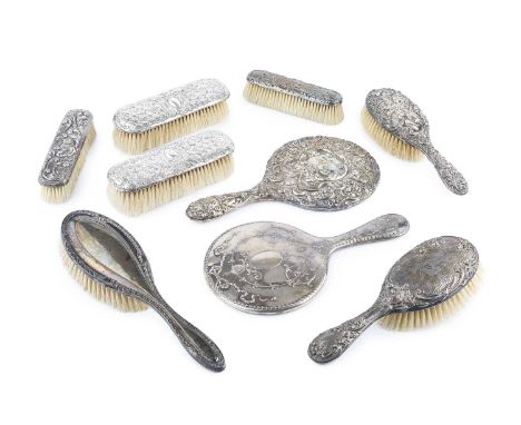 A collection of silver dressing table items, to include two hand mirrors, various hair and clothes brushes, a green guilloche