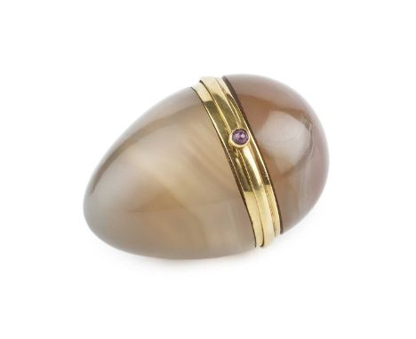 A gold mounted agate egg-shaped box, with cabochon ruby set thumbpiece, inscribed to the interior of the mount 'Mrs John F. E