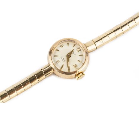 A lady's 9ct gold bracelet watch, the circular silvered dial with gilt Arabic quarters and arrowhead markers, signed W of S f