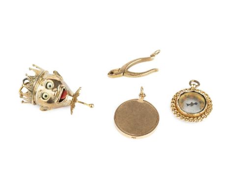 A collection of novelty pendants, comprising a 9ct gold and enamel pendant, modelled as a jester's head, with moveable eyes a