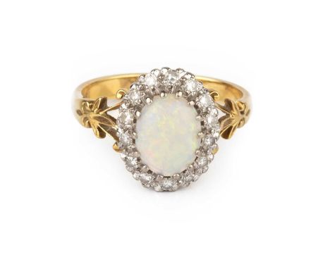 An opal and diamond cluster ring, the oval cabochon opal claw set within a border of single-cut diamonds, between scrolled sh