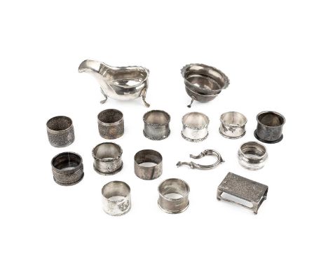 A collection of twelve silver napkin rings, various dates and makers, together with a silver sauce boat and sugar basin (both