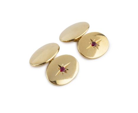 A pair of ruby set cufflinks, with oval panels and chain-link fittings, each cufflink inset with a circular mixed-cut ruby in