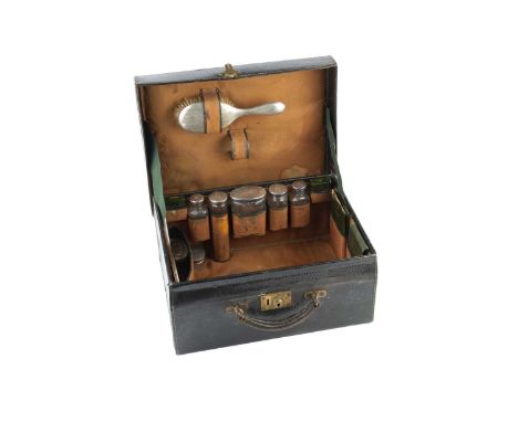 A George V silver backed dressing set, with engine turned decoration, comprising hand mirror, hair brush, and five silver top