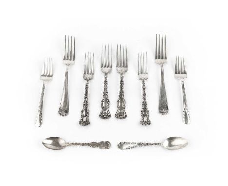 A set of six American silver table forks, with angular handles, a set of 7 American silver dessert forks, with ornate foliate