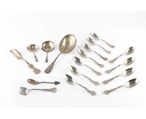 A set of eleven American silver teaspoons, with ornate cherub and foliate handles, a similar small serving fork by Tiffany &a