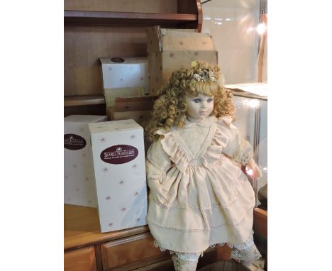 A collection of nine boxed ceramic dolls by Ashton drake leonardo and alberon.