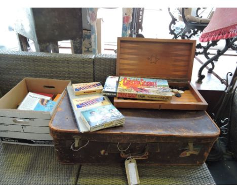 A vintage tan leather suitcase, backgammon set, vintage toys and sundries.