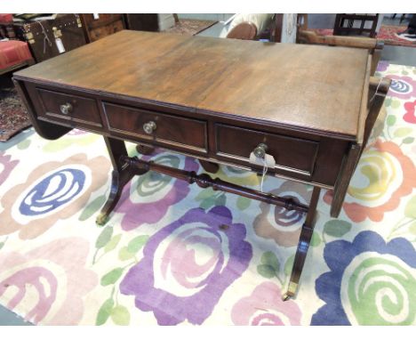 A George III style mahogany sofa table with twin flap top over three drawers on solid end standards with downswept feet. W. 8