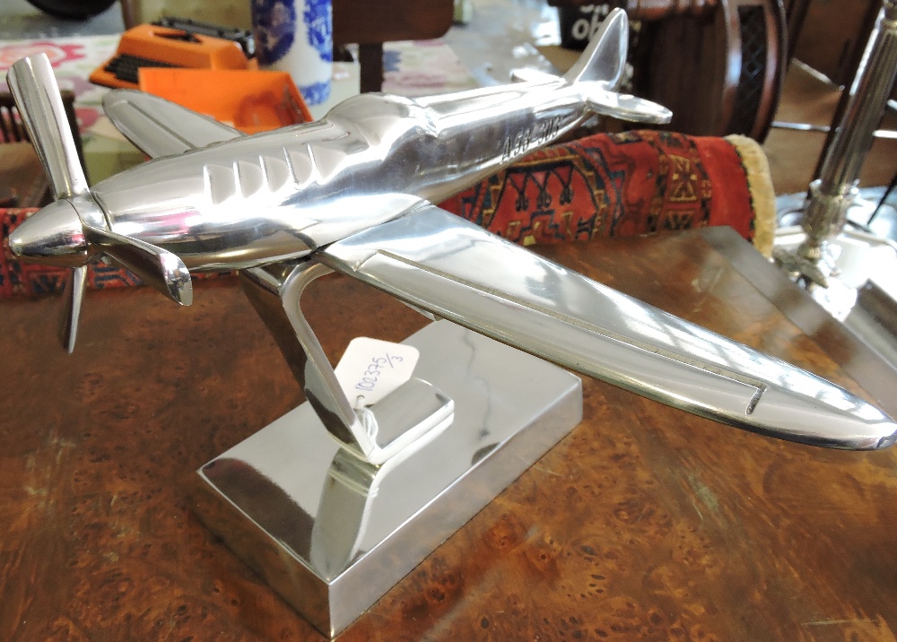 A chrome plated desk ornament modelled as a spitfire, H. 22cm.