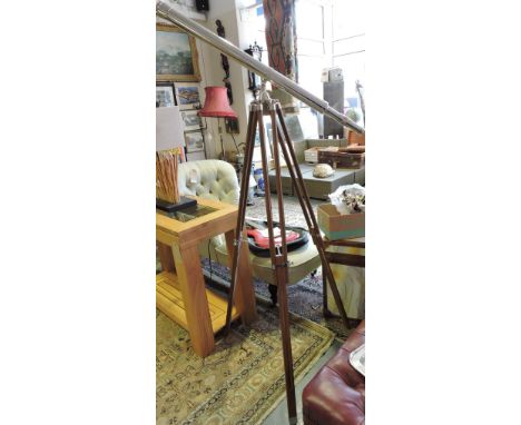 A vintage style plated telescope on adjustable wood tripod.