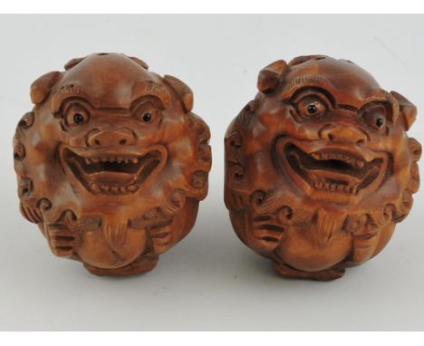 A pair of Chinese carved hardwood dogs of Fo netsuke.