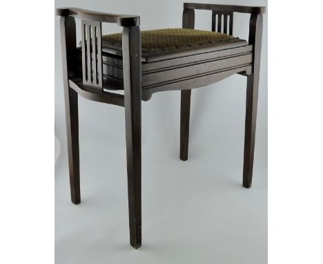 An Edwardian stained beech piano stool, with upholstered box seat on angular cabriole legs.