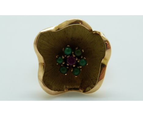 A 9ct gold ring in the form of a flower set with a ruby surrounded by turquoise, 5.9g (size I)