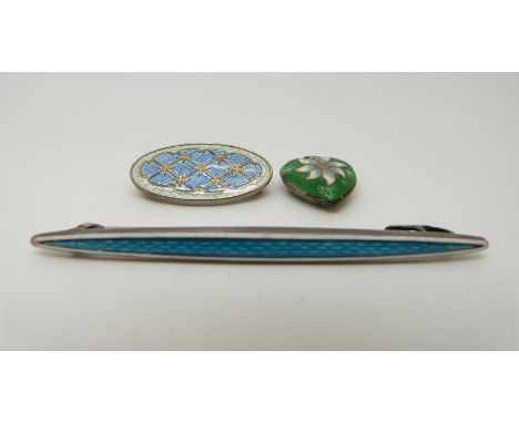 A hallmarked silver brooch, further silver brooch and a silver heart pendant all set with enamel 