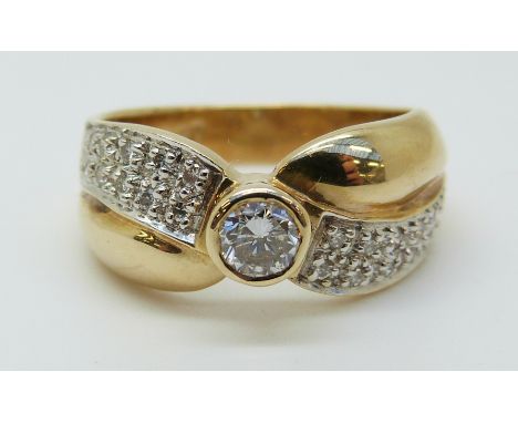 A 14ct gold ring set with a diamond with further diamonds to the shoulders, total diamond weight approximately 0.5ct (size M)