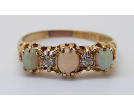 An 18ct gold ring set with three opal cabochons and two old cut diamonds (size S) 