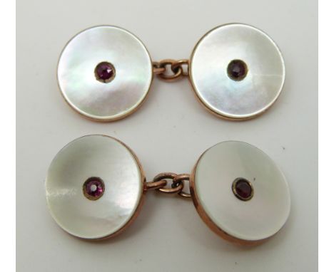 A pair of rose gold cufflinks set with pink paste to the centre and mother of pearl 