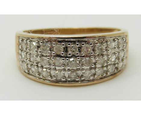 A 9ct gold ring set with diamonds in three rows, total diamond weight approximately 0.5ct, 2.69g (size O) 