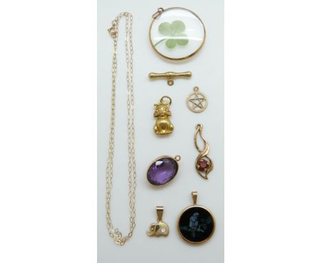 A 9ct gold pendant, a yellow metal pendant set with an amethyst, three 9ct gold pendants including a cat and a 9ct chain 