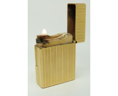 St.Dupont gold plated lighter with reeded decoration, signed to base 'St Dupont Paris Made in France BX3597' and with impress