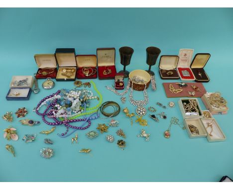 A collection of costume jewellery including brooches, necklaces, beads, Smiths pocket watch, a boxed Ronson lighter etc 