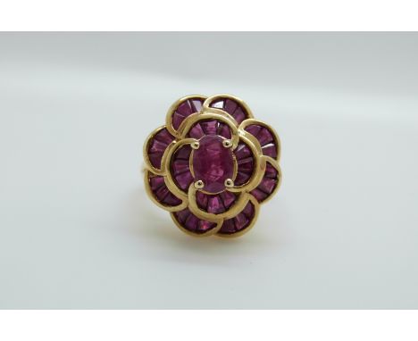 A 9ct gold ring set with synthetic rubies in a large cluster, 5.7g, size K 