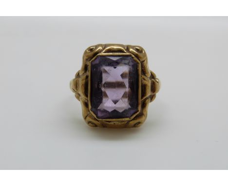 A yellow metal ring marked 333 set with an emerald cut amethyst, 3.3g, size N/O