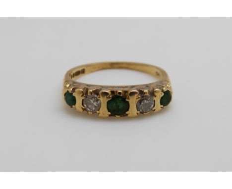 An 18ct gold ring set with emeralds and diamonds (size K) 