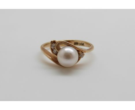 A 14ct gold ring set with a pearl and diamonds, 2.5g, size J 