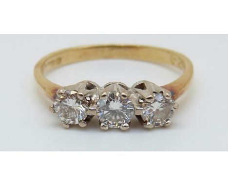 An 18ct gold ring set with three diamonds, total diamond weight approx 0.6ct (size K)