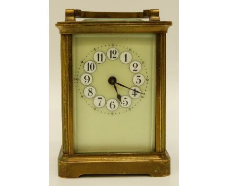 A mid 20thC brass cased carriage clock in corniche style case, the light green enamelled dial with contrasting raised Arabic 