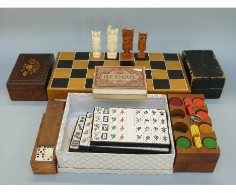 A collection of vintage games including cased Rubicon Bezique with two ivory mounted counters, walnut clip holder, bone domin