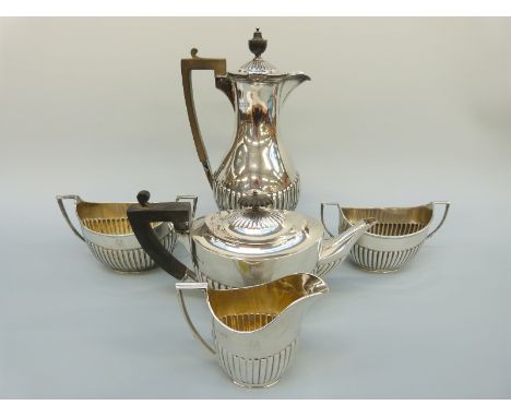 A Victorian and later five piece hallmarked silver tea set with reeded lower body comprising teapot, two sugar bowls, milk ju