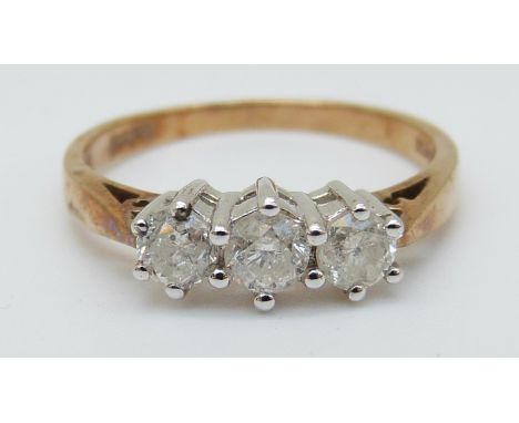 A 9ct gold ring set with three diamonds, total 0.5ct (size K)
