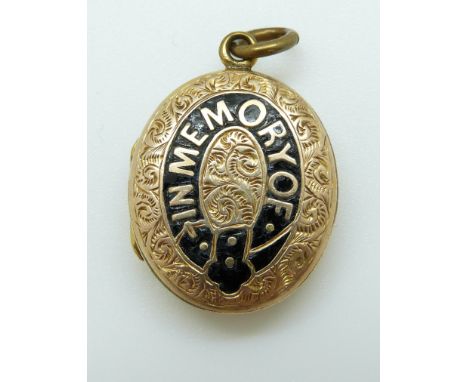 A Victorian locket reading 'In memory of' in black enamel with chased foliate design 