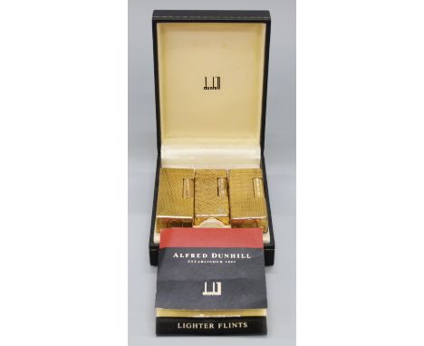 A boxed plated Dunhill lighter and two further Dunhill lighters, all with different engine turned/engraved decoration, all 6.